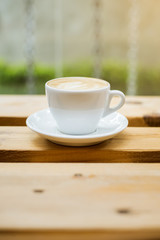 hot latte art on wood table background