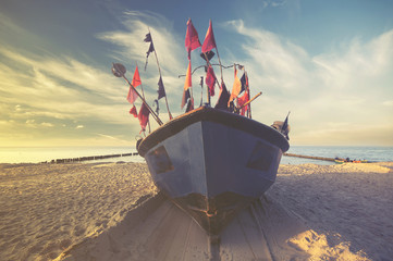 fishing boats on the sea beach,sunset ,Vintage retro stylized photo
