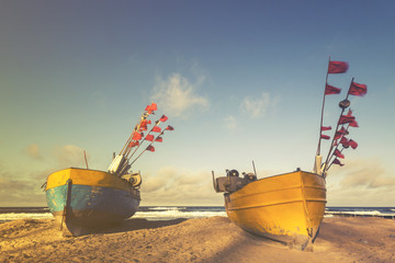 fishing boats on the sea beach,sunset ,Vintage retro stylized photo
