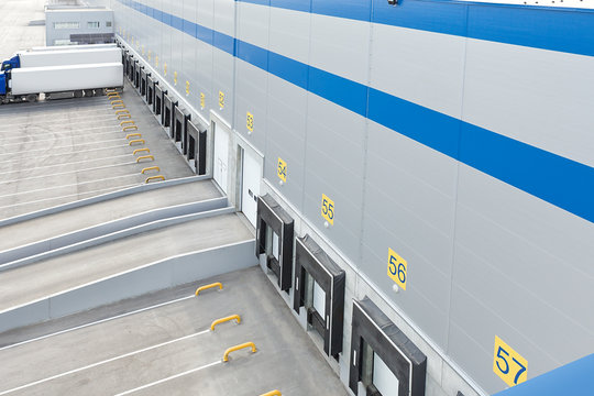 Big distribution warehouse with gates for loads and trucks