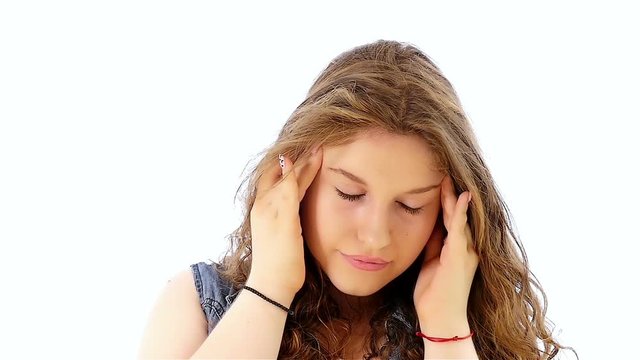 Teenager girl having headache on white background, slow motion