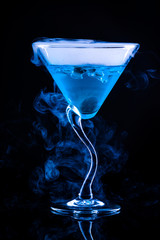 blue cocktail with splash and ice vapor