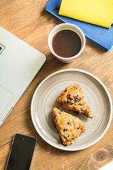 concept: workplace , computer, notebooks, home-made cakes