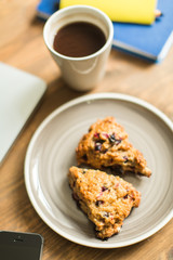 concept: workplace , computer, notebooks, home-made cakes