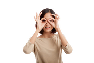 Asian woman do funny  double OK sign as glasses isolated on white background