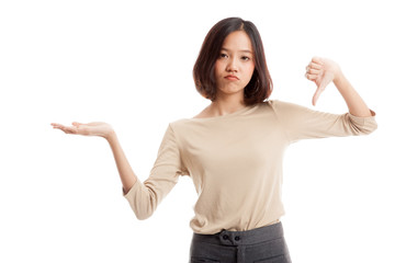 Young Asian woman show palm hand and thumbs down  isolated on white background