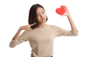 Asian business woman point to red heart  isolated on white background