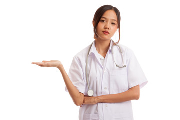 Asian young female doctor show something on her hand  isolated on white background