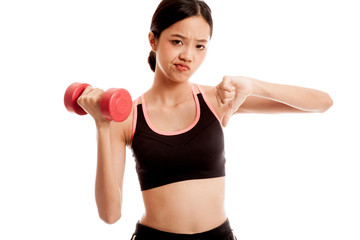 Fototapeta premium Beautiful Asian healthy girl thumbs down with dumbbell isolated on white background