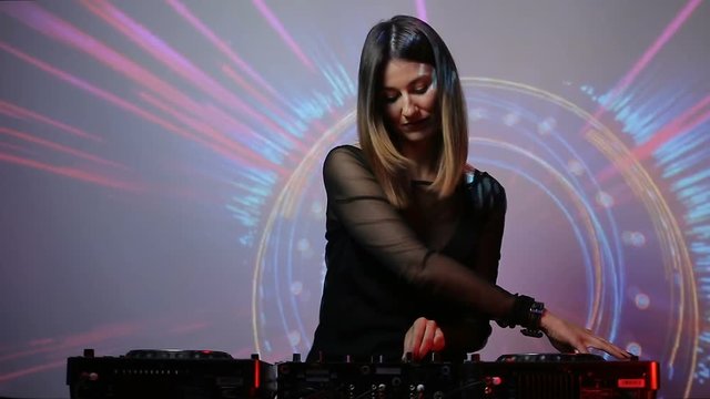 DJ girl on decks at the club