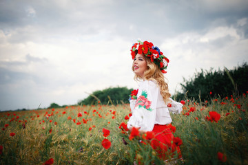 young beautiful woman with blond long hair in national dress red skirt and a white shirt with a...