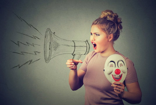 woman with clown mask screaming in megaphone