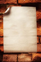 Empty paper sheet over old brick wall
