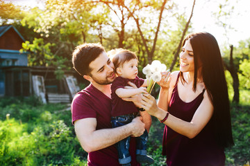 Naklejka premium young family with a child on the nature