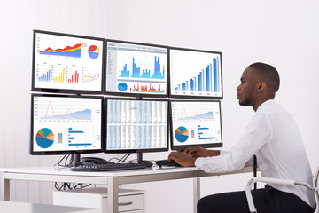 Businessman Analyzing Graph On Computer