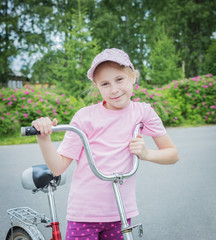 Beautiful young girl on a bicycle