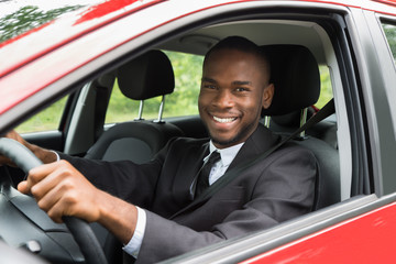 Happy Businessman Driving Car
