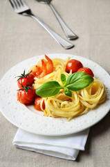 Linguini served with grilled cherry tomatoes and shrimps