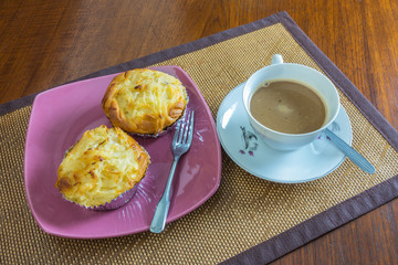 Denise coconut and coffee cup on a wooden table.