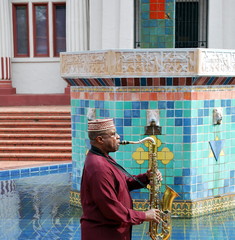 African american jazz saxophone player with his horn outdoors.