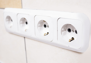 Closeup of Four Power Outlets Together in Line