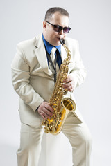 Portrait of Expressive Stylish Caucasian Saxophone Player Performing In Studio