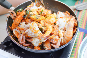 Fried shrimp ,squid and crab with basil with hot and spicy sour