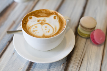 A cup of coffee with cupcakes