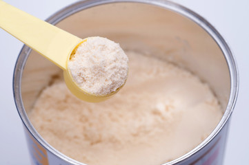 Baby milk powder in cans that open with a spoon.