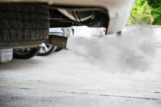 Fototapeta combustion fumes coming out of car exhaust pipe