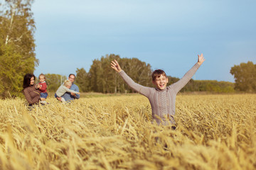 Happy family walk on a yellow field