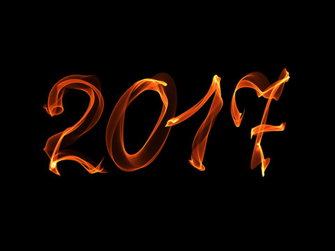 Happy new year 2017 isolated numbers written with flame light on black background