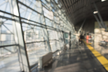 Blurred airport terminal background. Airport or railway hall interior in bokeh. International gate, business trip, arrival or mall. Urban construction.
