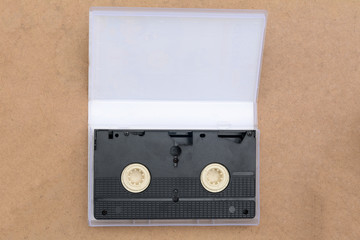 Fototapeta premium pile of videotapes on brown wooden floor background