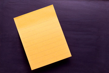 yellow sticky note with shade on blackboard