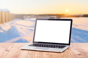 Laptop with blank screen on table. blurred background