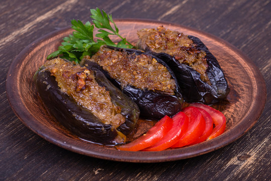 Baked eggplant stuffed with onions, cherry plums and walnuts