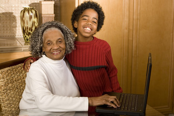 Grandson showing his grandmother how to use the computer.