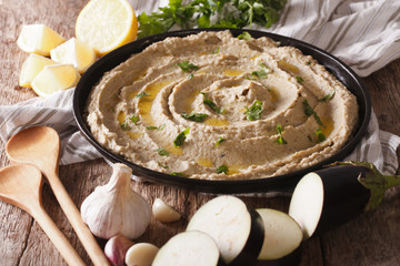 Arabic food baba ghanoush close-up on the plate and ingredients. horizontal
