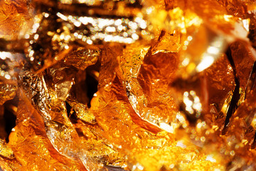 Shiny yellow and orange gold foil, abstract texture background.