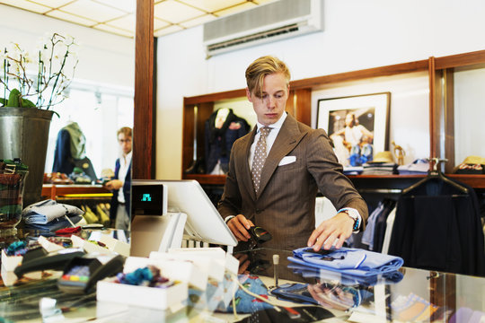 Owner holding bar code scanner while working in showroom