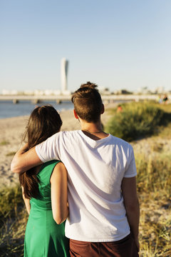 Rear view of couple standing on beach
