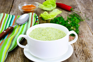 Soup Cream of Lettuce in a Wooden Bowl