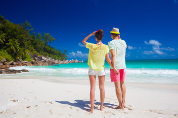 attractive couple enjoying sunny day at Maia Beach. Mahe, Seychelles