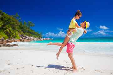 young family in love having fun at tropical Anse Goergette beach. Praslin, Seychelles