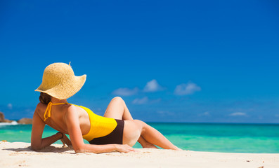 Fit woman in sun hat and bikini at beach.remote tropical beaches and countries. travel concept