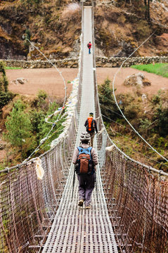 Trekkers and rope bridge on trekking route