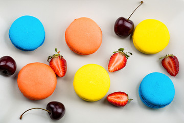 Macaroons and berries on the plate