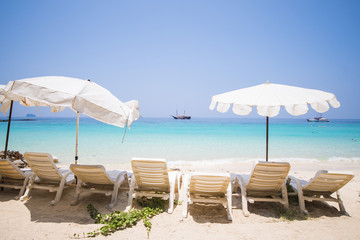 white plastic chair with big umbrella