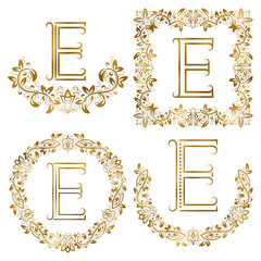 Golden E letter ornamental monograms set. Heraldic symbols in wreaths, square and round frames.